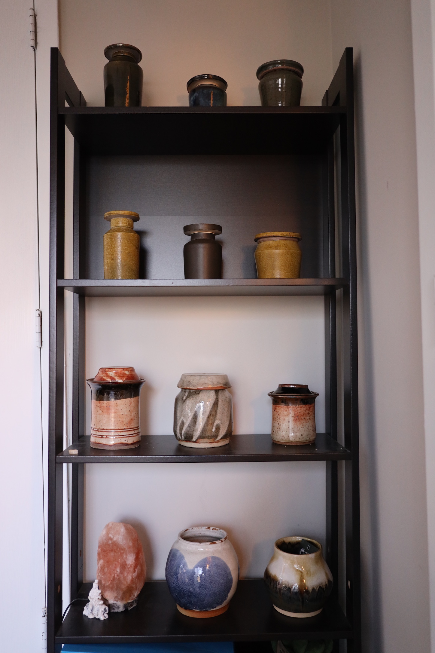 Handmade ceramic pottery collection on shelf - ceramic artist studio